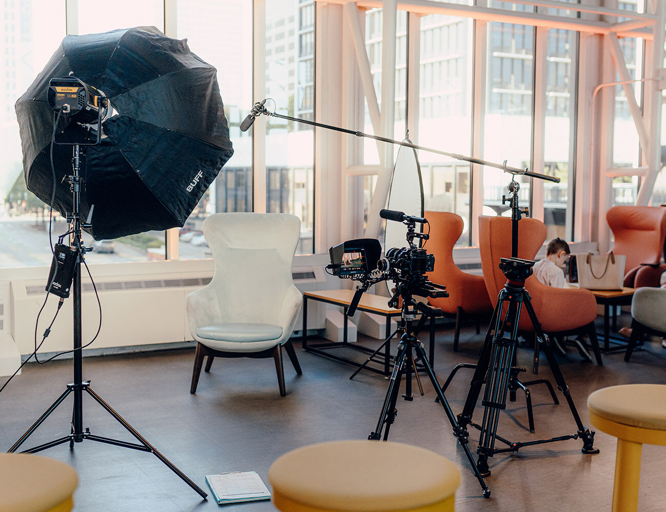 Camera, lighting and interview seating arranged for a commercial video production.