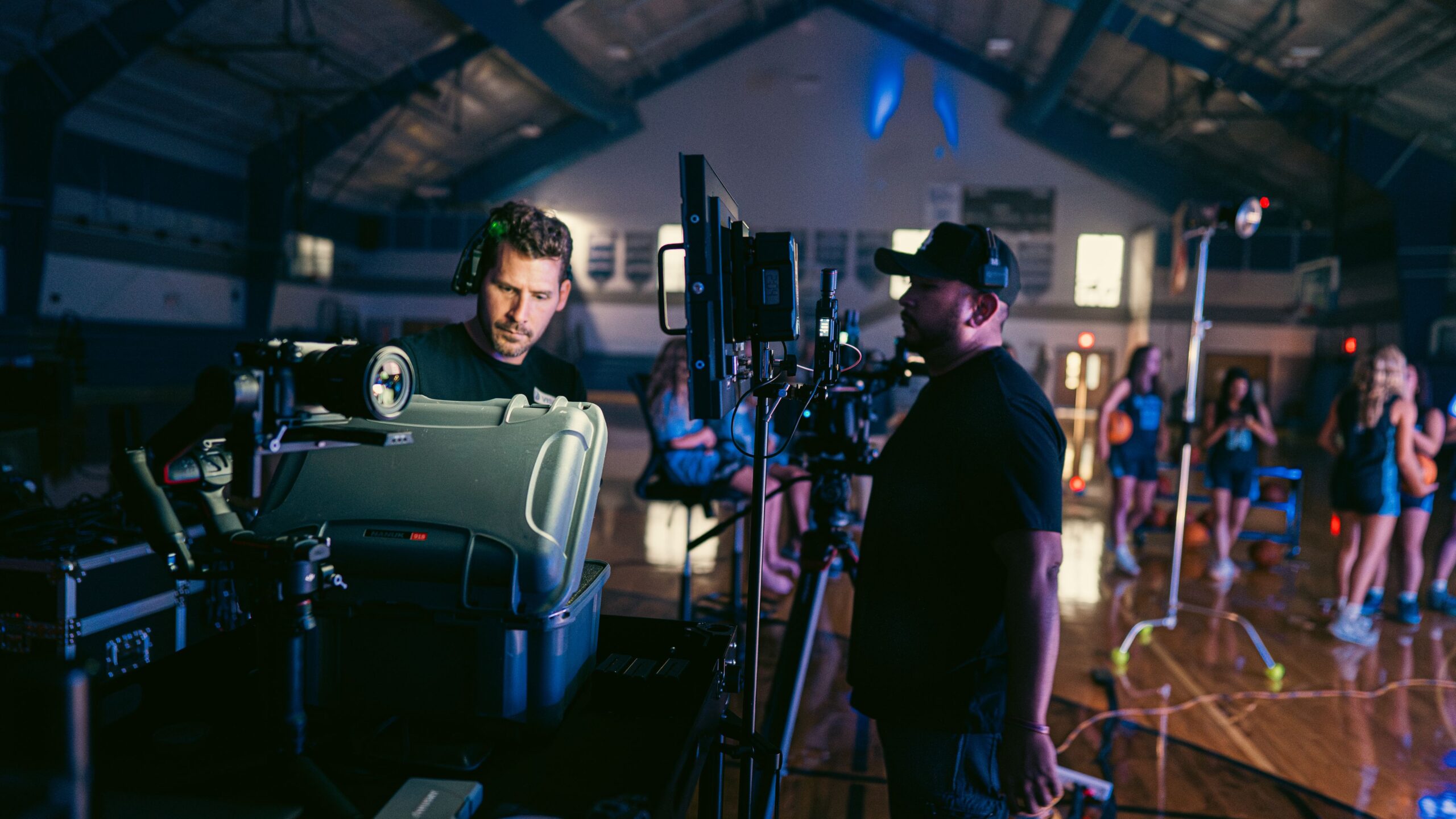 Camera operator Philip A. Young reviewing production equipment during a shoot at Grace Christian Academy.