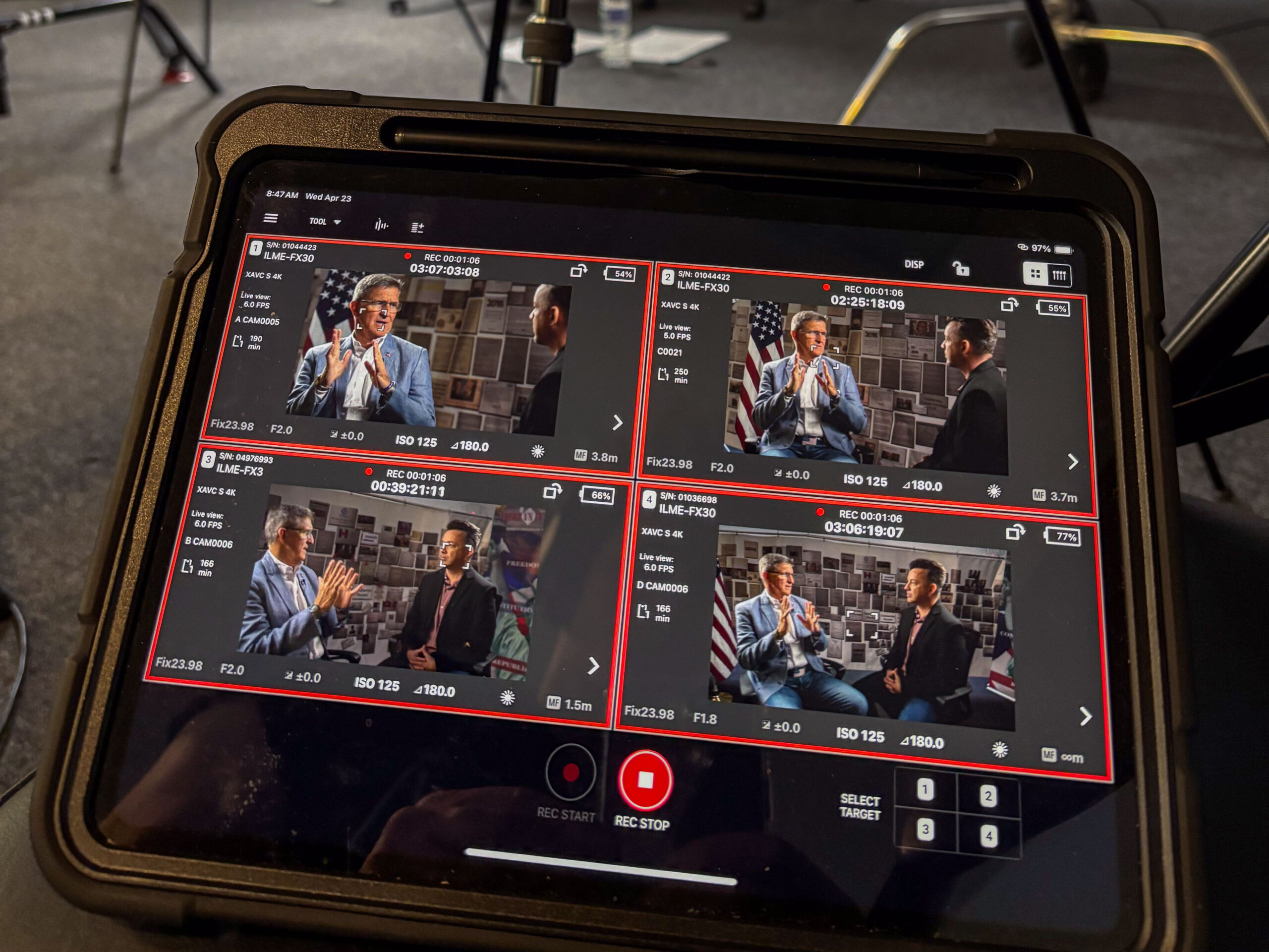 Tablet displaying four live camera feeds during a multi-camera interview production.