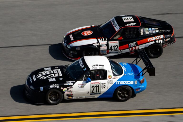 Two race cars competing closely during a ChampCar endurance race.