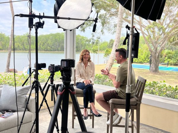 Camera, lighting and diffusion equipment set up for an outdoor commercial video production.